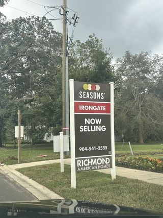 Community Amenities A welcoming sign for Irongate by Richmond American Homes in Jacksonville, FL, surrounded by lush greenery.