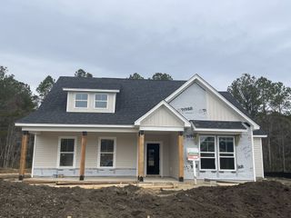 A charming new construction home with a covered porch in Timothy Lakes by Center Park Homes (Ridgeville, SC).