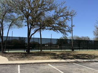 Street view Convenient tennis courts with surrounding trees in Stillwater Ranch by Coventry Homes (San Antonio, TX).