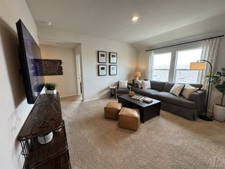 A bright and inviting living area with plush seating, natural light, and modern decor, ideal for family gatherings.