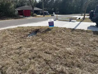 A lot for sale in The Collection at Ocklawaha by Century Complete, featuring a spacious lawn and residential road (Ocklawaha, FL).