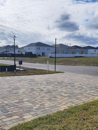 New construction homes line a spacious street in Seasons at Asher's Landing by Richmond American Homes (Jacksonville, FL).