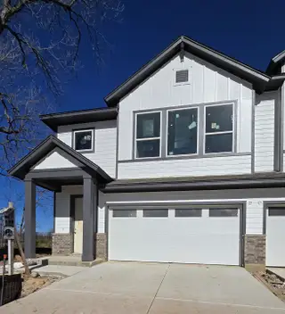 A modern white two-story home with a spacious garage in Easton Park - Nelson Village 29’ by David Weekley Homes (Austin, TX).
