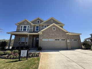 A charming two-story brick home with landscaped yard in Buffalo Crossing by Chesmar Homes (Cibolo, TX).
