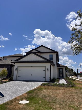 A modern white home with a clean driveway in Reunion Village by LGI Homes (Kissimmee, FL).