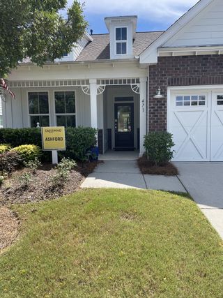 A charming brick and white home with elegant details in Cresswind Charleston by Kolter Homes (Summerville, SC).