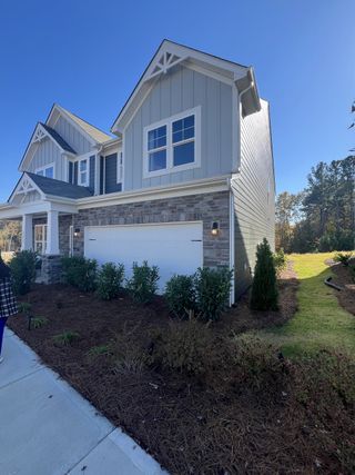 Street view A charming two-story home with a landscaped yard in Laurelbrook by M/I Homes (Sherrills Ford, NC).