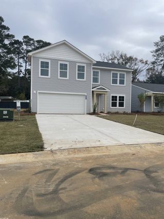 A modern gray two-story home with a spacious driveway in Essence at Chandler Crossing by Stanley Martin Homes (Summerville, SC).