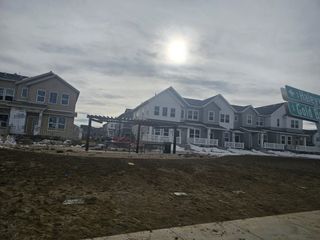Street view Charming modern townhomes with covered porches in Gateway Commons by Lokal Homes, Denver, CO.