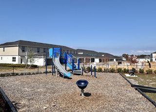 Community Amenities A fun-filled community playground with slides, climbing structures, and open green space in Emerson Pointe by M/I Homes (Apopka, FL).
