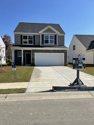 A charming two-story home with a sleek exterior in Oakley Pointe by Eastwood Homes (Moncks Corner, SC).