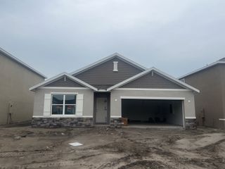 A modern single-story home in the early stages of construction, featuring a wide garage in Mirada by D.R. Horton (San Antonio, FL).