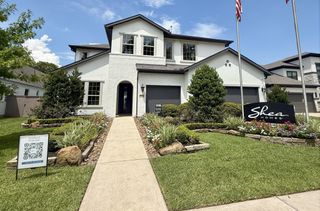A beautiful white brick home with manicured landscaping in Sienna 65' by Shea Homes, Missouri City, TX.