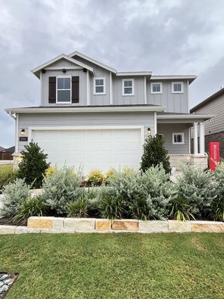 Street view A charming gray home with manicured landscaping in Ashford Crossing by Centex (Princeton, TX).
