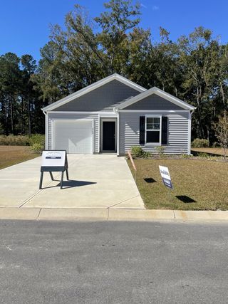 A charming gray home with a neat facade and driveway in Evergreen by D.R. Horton (Holly Hill, SC).