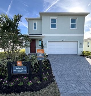 A modern two-story home with a landscaped entry in Riverwood at Everlands by Lennar (Palm Bay, FL).