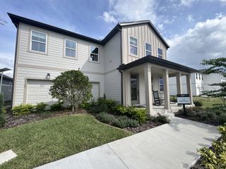 A modern two-story home with a lush yard in Trailside by Ashton Woods (Mount Dora, FL).