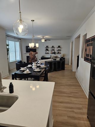 An open-concept living area featuring a fireplace, chic furnishings, and abundant natural light.