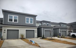 Stylish gray townhomes with modern design in Pine Series at The Landings at Pecan Park by Century Communities (Jacksonville, FL).