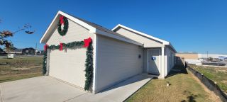 Charming beige home with festive wreaths and bows in Aston Park: Wellton Collection by Lennar (San Antonio, TX).