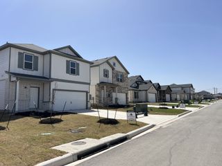 Modern homes with sleek exteriors and manicured lawns in Cool Water by M/I Homes (Jarrell, TX).