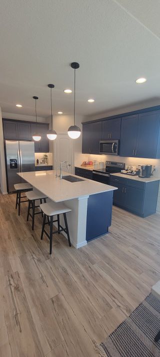 A spacious kitchen with sleek cabinetry, modern lighting, and a large island ideal for cooking and entertaining.

