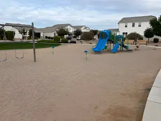 Community Amenities A welcoming playground with slides and swings in Pecan Cove by Newport Homes, San Tan Valley, AZ.