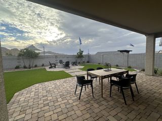 A spacious covered patio with paver flooring, perfect for outdoor dining and entertaining.