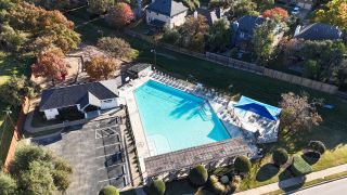 Aerial view of a community pool and clubhouse in Sauls Ranch East by Coventry Homes (Round Rock, TX).
