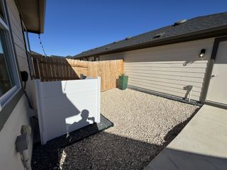 A neat outdoor space with gravel and privacy fencing.