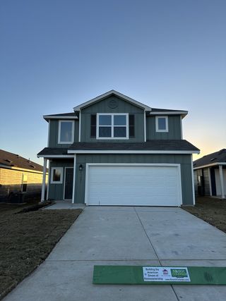 A modern gray two-story home with a white garage in Hidden Oasis by Lennar (San Antonio, TX).