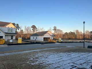 New construction site with homes in progress at Green Hill by Starlight Homes in Louisburg, NC.