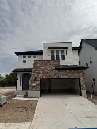 Modern two-story home with brick and siding facade in Foxfield by Milestone Community Builders (Austin, TX).