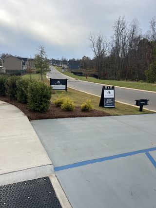 A charming neighborhood street with modern homes in Sanders Ridge by M/I Homes (Troutman, NC).