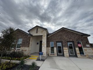 A charming brick and stone home at Woodfield Preserve: Highlands Collection by Lennar in Georgetown, TX.
