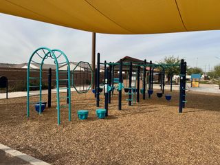 Community Amenities A vibrant playground with modern equipment and shade in Bridle Park at Alamar by Richmond American Homes (Avondale, AZ).