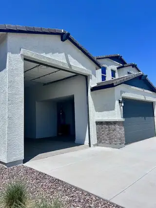 Street view A modern two-story home with sleek gray accents in Laveen Vistas II by Homes by Towne (Phoenix, AZ).