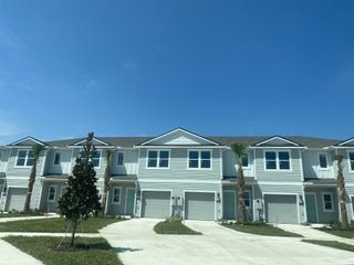 Modern townhomes with clean lines and palm trees in The Landing by D.R. Horton, Middleburg, FL.