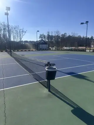 Modern tennis courts with scenic views in the Independence community by D.R. Horton (Loganville, GA).