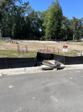Street view Future home site with lush wooded backdrop in Fiddler Cove by DRB Homes, Mount Pleasant, SC.