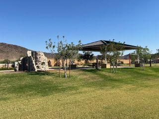 Community Amenities A scenic park with rock climbing structures and a pavilion in Laveen Vistas III by Homes by Towne (Laveen, AZ).