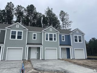 Street view Stylish townhomes with colorful facades in The Townes at Merrimack by D.R. Horton (Moncks Corner, SC).