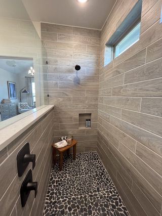 A stylish en-suite bathroom featuring a double vanity, elegant lighting, and modern finishes in Solterra by David Weekley Homes (Mesquite, TX).