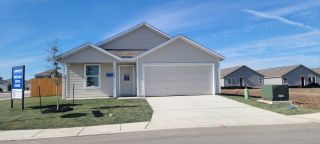 Street view Inviting single-story home with modern design in Savannah Place by Lennar, Converse, TX. Well-manicured lawn.