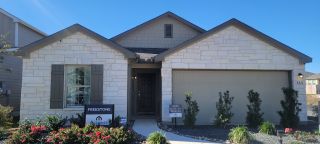 A charming stone facade home with landscaped entry in Boardwalk by M/I Homes, St. Hedwig, TX.