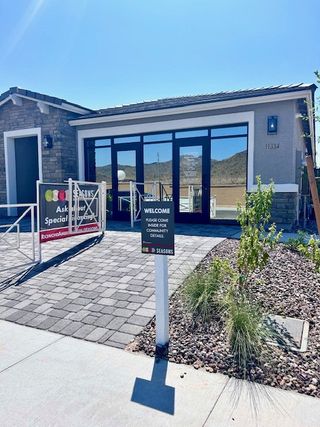 A modern model home with stone accents and large windows in Seasons at Laveen Vistas by Richmond American Homes (Phoenix, AZ).
