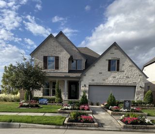 A charming stone home with lush landscaping in Bridgeland: Premier Collection by Beazer Homes (Cypress, TX).