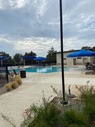 Inviting community pool with shaded seating in Lively Ranch: Claremont Collection by Lennar (Georgetown, TX).