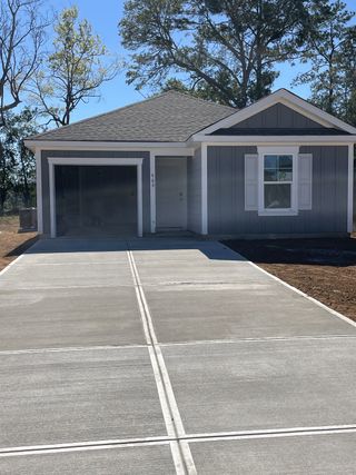 Charming gray home with white shutters and spacious driveway in Center Pointe by D.R. Horton (Santee, SC).