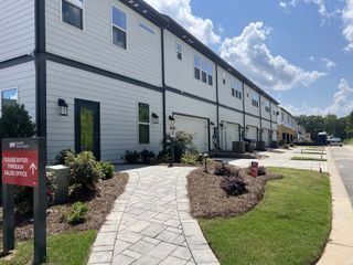 Street view Modern townhomes with sleek design and landscaped paths in Ridge at Sugar Creek by Taylor Morrison (Indian Land, SC).